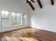 Spacious bedroom with hardwood floors, vaulted ceiling, wood beams, and abundant natural light at 3908 Sage Ct, Wake Forest, NC 27587
