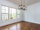 Bright dining room with hardwood floors, decorative molding, and a modern chandelier at 3908 Sage Ct, Wake Forest, NC 27587