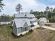 Beautiful two-story home with gray siding, white trim, a manicured lawn, and a three car garage at 3908 Sage Ct, Wake Forest, NC 27587
