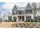 Charming exterior view of a home featuring gray siding, stone accents and well-manicured landscaping at 3908 Sage Ct, Wake Forest, NC 27587