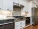 Updated kitchen featuring stainless steel appliances and granite countertops at 3908 Sage Ct, Wake Forest, NC 27587