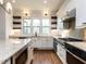 Modern kitchen with white cabinetry, granite countertops, and stainless steel appliances at 3908 Sage Ct, Wake Forest, NC 27587