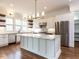 Gourmet kitchen with large island, stainless steel appliances, and granite countertops at 3908 Sage Ct, Wake Forest, NC 27587