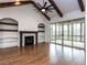Spacious living room with beamed ceilings, fireplace, built-ins, and access to screened porch at 3908 Sage Ct, Wake Forest, NC 27587