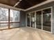 Spacious screened-in porch with wood flooring, sliding glass doors, and wooden railing at 3908 Sage Ct, Wake Forest, NC 27587