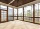 Spacious screened-in porch with wood ceiling, wooden railing, and view of backyard at 3908 Sage Ct, Wake Forest, NC 27587