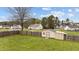 Fenced backyard featuring a storage shed, mature trees, and ample green space for outdoor activities at 40 Hill Rd, Franklinton, NC 27525