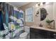 A stylish bathroom with a Stormtrooper themed shower curtain and decorative round mirror at 40 Hill Rd, Franklinton, NC 27525
