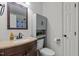 This bright bathroom features a granite sink and a rustic-style cabinet at 40 Hill Rd, Franklinton, NC 27525