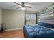 A comforting bedroom with a ceiling fan and a large window overlooking the lush outdoors at 40 Hill Rd, Franklinton, NC 27525