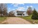 A cozy one-story home with a white exterior, a gray roof, a gravel driveway, and a well-manicured lawn at 40 Hill Rd, Franklinton, NC 27525