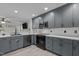 Stylish kitchen featuring gray cabinetry, stainless steel appliances, and elegant countertops at 40 Hill Rd, Franklinton, NC 27525