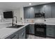 Modern kitchen with sleek gray cabinets, stainless steel appliances, and a white subway tile backsplash at 40 Hill Rd, Franklinton, NC 27525