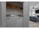 Functional laundry room with a washer, a dryer, and shelving for storage, conveniently located near the living area at 40 Hill Rd, Franklinton, NC 27525