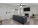 Bright living room featuring a fireplace, mounted television, ceiling fan, and a comfy gray sectional sofa at 40 Hill Rd, Franklinton, NC 27525