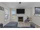 Comfortable living room with fireplace, mounted TV, and a view into the modern kitchen area at 40 Hill Rd, Franklinton, NC 27525