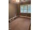 Serene bedroom with neutral walls, carpet, and ample natural light through the windows at 4001 W Antioch Dr, Oxford, NC 27565