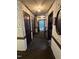 Long hallway featuring classic wallpaper and hardwood doors, and a dark patterned carpet at 4001 W Antioch Dr, Oxford, NC 27565