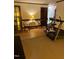 Open-concept living space with wood floors and various workout and music equipment at 4001 W Antioch Dr, Oxford, NC 27565
