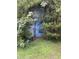 Image of the shed with overgrown landscaping, perfect for storage and outdoor needs at 4001 W Antioch Dr, Oxford, NC 27565