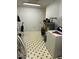Functional utility room with washer, water heater, and practical tile flooring at 4001 W Antioch Dr, Oxford, NC 27565