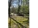 View of the spacious, shady yard with trees, offering plenty of outdoor space at 4001 W Antioch Dr, Oxford, NC 27565