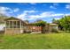A well-maintained backyard with a covered porch, patio, pergola and lush green lawn provide multiple entertainment areas at 407 W Cornwall Rd, Cary, NC 27511