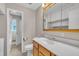 Cozy bathroom featuring vanity storage, a standard toilet, and an open door with shower view at 407 W Cornwall Rd, Cary, NC 27511