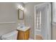 Well-lit bathroom featuring a sink with a wooden cabinet at 407 W Cornwall Rd, Cary, NC 27511