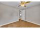 Neutral bedroom featuring wood floors, a ceiling fan, and an open door to another room at 407 W Cornwall Rd, Cary, NC 27511