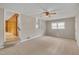 Comfortable bedroom with neutral walls, soft carpeting, ceiling fan, and a doorway to another room at 407 W Cornwall Rd, Cary, NC 27511
