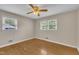 Bedroom with wood floors, windows, and natural light; view of the outside landscape at 407 W Cornwall Rd, Cary, NC 27511