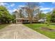 Well-kept ranch-style house with a long driveway and landscaping, showcasing suburban appeal at 407 W Cornwall Rd, Cary, NC 27511