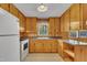 Classic eat-in kitchen featuring knotty pine cabinetry, laminate countertops, and a window view at 407 W Cornwall Rd, Cary, NC 27511