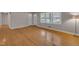 Inviting living room boasts gleaming hardwood floors, large windows, and fresh neutral paint at 407 W Cornwall Rd, Cary, NC 27511