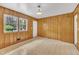 Bright, wood-paneled room with large windows, providing an abundance of natural light and views at 407 W Cornwall Rd, Cary, NC 27511