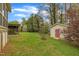 Backyard with a storage shed and mature trees at 407 W Cornwall Rd, Cary, NC 27511