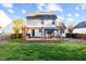 Lush backyard featuring a wooden deck, manicured lawn, and a privacy fence, creating a serene outdoor space at 409 Machost Dr, Garner, NC 27529
