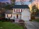 Charming two-story home with red shutters, inviting front porch, and attached garage, perfect for suburban living at 409 Machost Dr, Garner, NC 27529