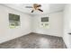 Cozy bedroom boasts a unique ceiling fan, wood-look floors, and bright windows at 415 Estell St, Rocky Mount, NC 27803