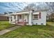Charming one-story home with a covered porch and red and white awnings at 415 Estell St, Rocky Mount, NC 27803