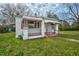 Side view of home featuring white siding, covered porch, and red and white awnings at 415 Estell St, Rocky Mount, NC 27803