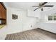 Bright kitchen featuring a ceiling fan, white cabinets, and gray floors at 415 Estell St, Rocky Mount, NC 27803