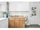 Bright kitchen featuring tan counters, wood cabinets and a door at 415 Estell St, Rocky Mount, NC 27803