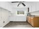 Bright kitchen features white and wood cabinets, and gray floors at 415 Estell St, Rocky Mount, NC 27803