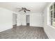 Bright living room features gray wood-look floors, neutral walls, and ceiling fan at 415 Estell St, Rocky Mount, NC 27803