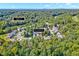 Overhead view of a home nestled within a lush, green neighborhood with mature trees at 44 Grandwood Cir, Durham, NC 27712