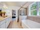 Serene bathroom featuring a soaking tub, glass shower, and double vanity at 44 Grandwood Cir, Durham, NC 27712