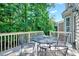 Outdoor deck with seating, surrounded by lush greenery and a glimpse of the house's architecture at 44 Grandwood Cir, Durham, NC 27712