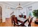 Spacious dining room with hardwood floors, elegant lighting, and ample space for entertaining at 44 Grandwood Cir, Durham, NC 27712